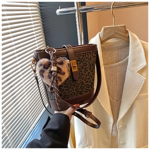 Detail view of vintage bucket bag with leopard print canvas and golden metal lock