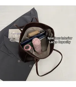 Top view of deep brown tote bag interior showing large capacity and daily essentials