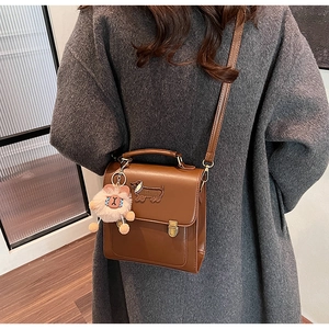 Brown vintage PU leather bag with embroidered dachshund and pink plush pendant charm
