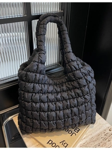 Black quilted puffer tote bag with large capacity and soft cloud padding design