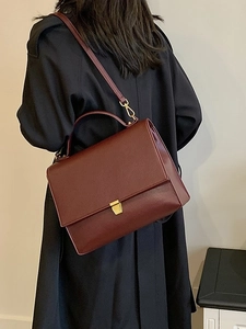 Vintage burgundy leather crossbody bag with lychee texture and gold buckle detail