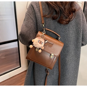 Brown vintage leather shoulder bag with dachshund embroidery and plush cat pendant