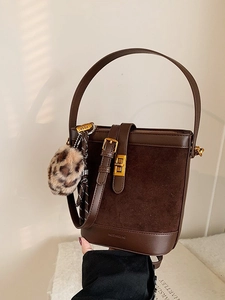 Retro coffee brown bucket bag with gold hardware and leopard faux fur pompom charm