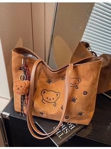 Brown faux suede tote bag with cartoon bear embroidery and plush charm accessory