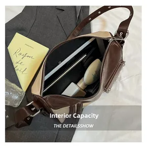 Detail view of large interior capacity showing tablet and phone inside a retro pillow bag