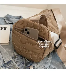 Detail of brown quilted canvas bag with teddy bear pattern and internal zipper pocket