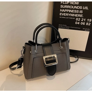 Close-up of stylish bucket bag with silver metal buckle and textured fabric finish