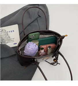Interior view of spacious dark brown leather tote bag with tablet and daily essentials