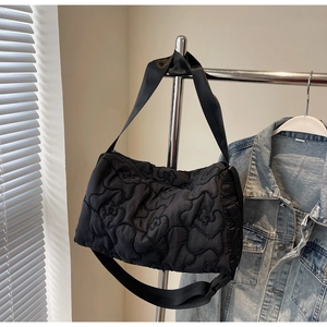 Fashionable black quilted puffer shoulder bag with 3D floral pattern and wide strap
