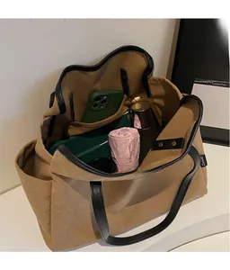 Interior view of khaki canvas tote showing spacious compartments with daily essentials