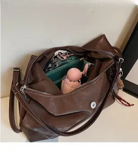 Top view showing large capacity interior of a brown vintage leather tote with metal zipper