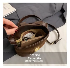Top view of brown suede bucket bag interior showing capacity for phone and cosmetics