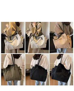 Detail view of large canvas tote bag showing side pockets in four earth tone colors