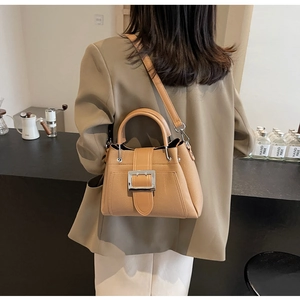 Detailed back view of a camel leather bucket bag with a stylish silver metal buckle decoration