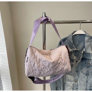 Chic lavender quilted crossbody bag with stylish cloud pattern and wide nylon strap