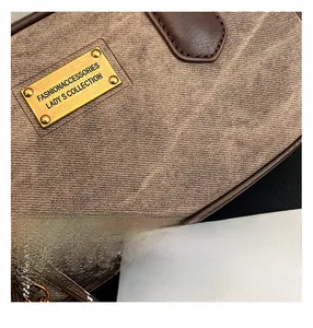 Close-up of leopard pattern fabric with gold logo plate and braided handle on a small square bag