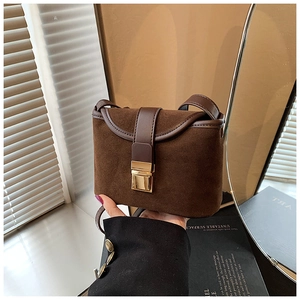 Close-up of deep brown frosted suede bucket bag with gold square buckle detail