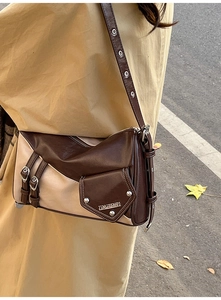 Detail of vintage patchwork shoulder bag with silver hardware and adjustable eyelet strap