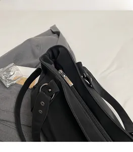 Détail de la fermeture éclair argentée et des oeillets sur le sac cabas en similicuir
