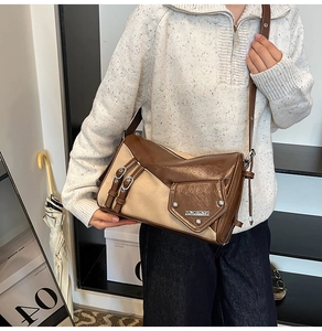 Detail of vintage patchwork shoulder bag with silver buckle and adjustable strap