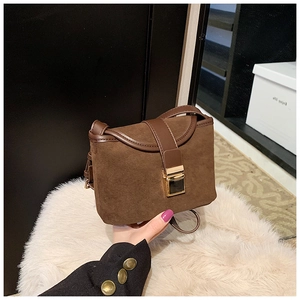 Close-up of retro brown frosted crossbody bag with a sleek gold rectangular metal buckle
