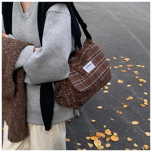 Detailed view of brown checkered fabric crossbody bag with a retro vintage pattern