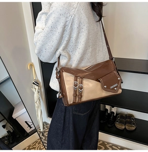 Detail of vintage patchwork shoulder bag with silver buckles and asymmetrical pockets