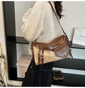 Detail shot of a retro patchwork underarm bag showing the chic brown and beige PU leather