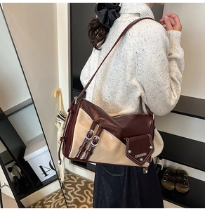 Detail of vintage patchwork shoulder bag showing texture and buckle straps in use