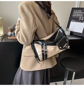 Detail of vintage patchwork shoulder bag with glossy black and beige leather finish