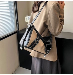 Detail of vintage patchwork shoulder bag featuring side buckles and a black utility pocket