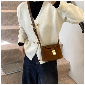 Brown frosted suede bucket bag detail with gold clasp closure and adjustable strap