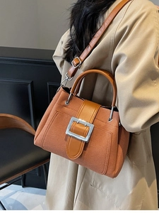 Chic caramel woven bucket bag with leather straps and silver buckle for women