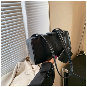 Close-up of black PU leather shoulder bag with a matching small accessory pouch