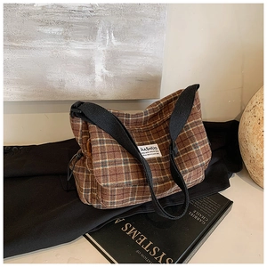 Macro shot of retro plaid canvas shoulder bag with JIASHUO woven label detail