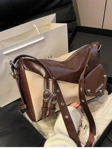Vintage patchwork shoulder bag in brown and beige with metallic stud decorations