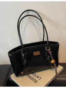 Retro black glossy leather tote bag with gold metal plate and woven ball charm