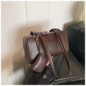 Detail of vintage dark brown faux leather pillow bag with small detachable coin purse