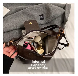 Top-down view of spacious dark brown bag interior with pockets and daily essentials