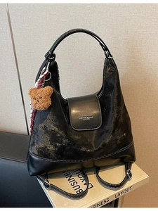 Retro black textured tote bag with large capacity and cute bear charm shown in studio setting