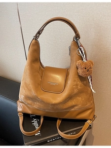 Brown large capacity leather hobo tote bag with a cute bear charm and wide shoulder strap