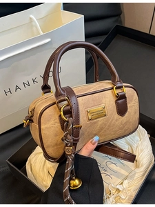 Retro Boston handbag in brown PU leather with decorative metallic tag and woven lanyard