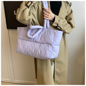 Close-up of lavender quilted puffer tote bag with soft padded handle texture