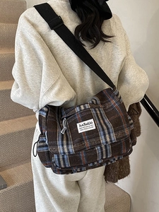 Vintage checkered crossbody bag with wide nylon strap and woven plaid pattern