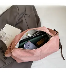 Detail showing spacious interior of pink suede tote bag with herringbone lining