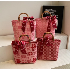 Close-up of Chinese wedding tote bags with bamboo handles and silk bow accents