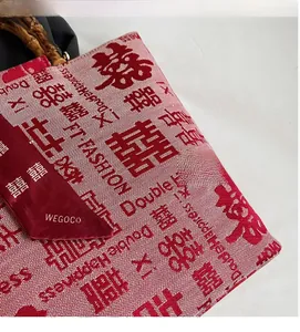 Detailed close-up of red Double Happiness wedding tote bag with bamboo handles and scarf
