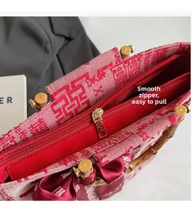 Detailed close-up of smooth gold zipper and red lining inside the bridal woven tote bag