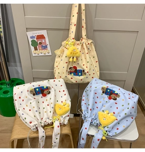 Three colorful polka dot drawstring tote bags with cute cartoon dog plush patches