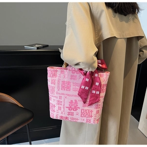 Pink fabric tote with bamboo handle, Chinese character patterns, and red scarf detail